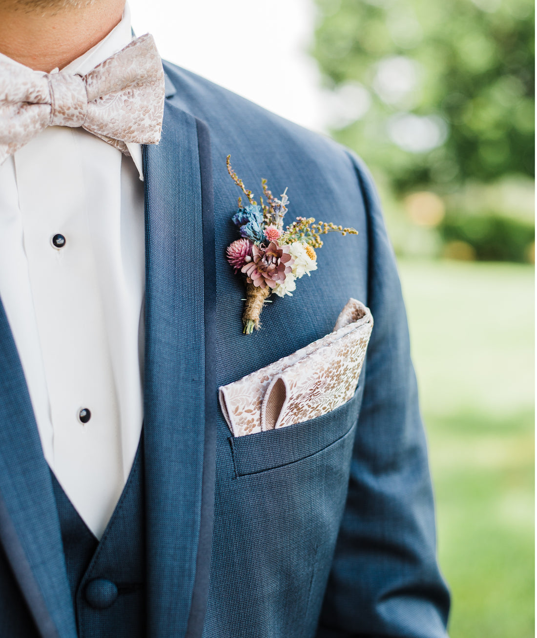 wedding suit with bow tie and floral button hole